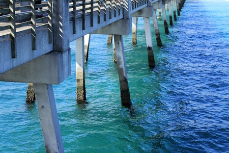 The pilings and foundation structure of an Atlantic ocean cement pier or dock seen from the pier の写真素材