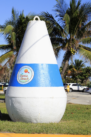 Dania Beach, FL, USA - December 7, 2014: One very large cement buoy with a sign on it that says Broward s First City, Dania Beach, Incorporated 1904. A large buoy at a park entranceのeditorial素材