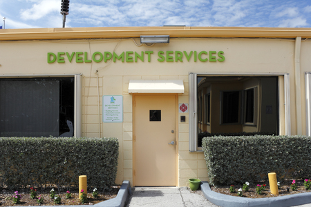 Lauderdale-by-the-Sea, FL, USA - May 16, 2015: Development Services building exterior front entrance. Development Services signs and office entrance on a sunny day. Development services is where they handle building permits, code enforcement and planning のeditorial素材