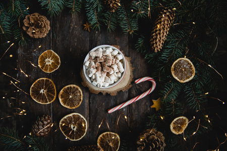 Christmas background candy cane branches Hot Chocolate Beverage dried orange slices on dark background. Holiday card. Top view flat lay.の写真素材