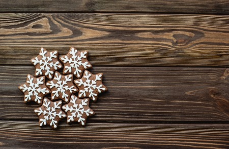 Gingerbread cookies snowflakes on wood table. copy space. Christms or New Year concept card.の写真素材