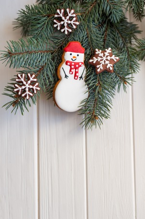Christmas gingerbread cookie fir cones on spruce branches on wooden background. top view. Christmas or New Year card.の写真素材