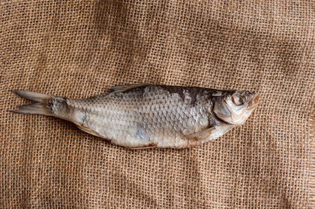 close-up dried river fish on bagging background. Top view. copy space.