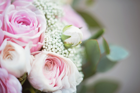stylish wedding attributes of bride. beautiful bouquet of white roses and ranunculus. Declaration of love, spring. Wedding card, Valentine. classic bride's bouquet. Soft selective focus.の写真素材