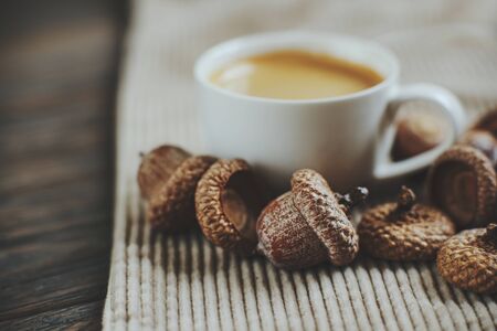 cup of acorn coffee on corduroy background. Space for text. Cozy Autumn image. Acorn autumn brown background. Selective focus. Macro view. Food trend. coffee substituteの写真素材