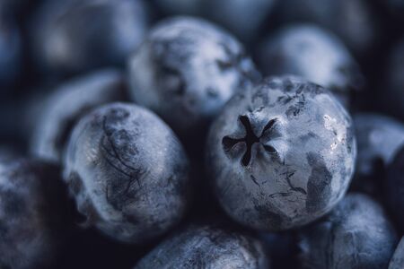 Wet fresh Blueberry background. close up with selective focus and water droplets. Concept of healthy and dieting eatingの写真素材
