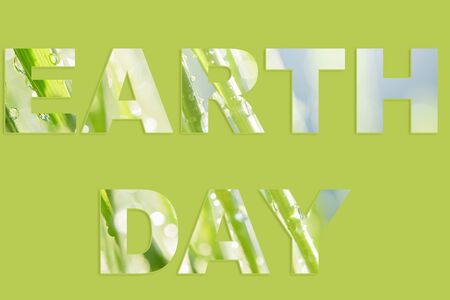 April 22, Earth Day words made of of green grass with drops of water within letters and sample greeting text. concept eco earth dayの写真素材