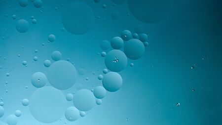 oil with bubbles on dark blue background. Abstract space background. Soft selective focus. macro of...