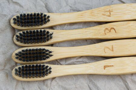 Set of bamboo toothbrushes with black brush bristles. Dental care with eco friendly bamboo tooth...