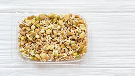 Healthy diet and vegetarian food. Mix of fresh sprouts on white background. macrobiotic food. Sprouted wheat, peas, lentil seeds. Superfood. Copy spaceの写真素材