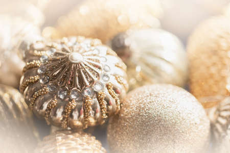 macro gold Christmas toys background. Preparing to decorate Christmas tree. New Year decoration. Festive holiday mood. Selective focus. Christmas card.の写真素材
