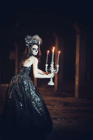 Closeup portrait of Calavera Catrina in black dress. Sugar skull makeup. Dia de los muertos. Day of The Dead. Halloween.の写真素材