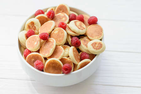 Delicious freshly cooked Homemade Mini Pancake with raspberries. Trendy food. Top view. breakfast food for kids.の写真素材