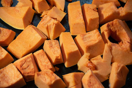 Raw Pumpkin slices pieces cut for baked. Healthy, vegan or vegetarian food.の写真素材