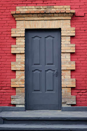 Gray front door of a red House. View of Beautiful House Exterior backgroundの写真素材