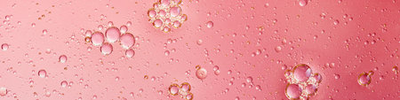 oil with bubbles on coral background. Pink Abstract space background. Soft selective focus. macro of...