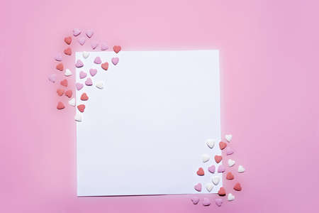 Greeting card for Valentine day. pink background and sugar hearts copy space. Happy valentineの写真素材