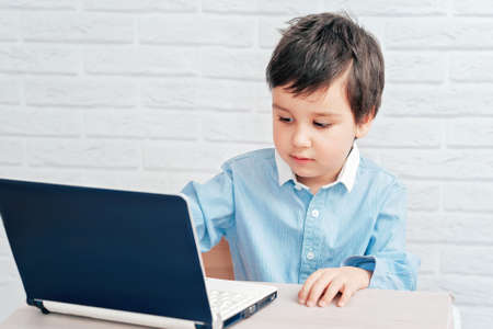 Concept of little businessman, webmaster, programmer, developer, Website designer. Little child and...