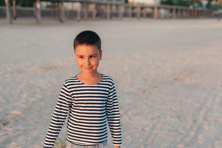 summer vacation at sea. Boy at seaside. Child collect shells on beach having fun during summer holiday. happy kid playing at sunset time. Happy childhood. Travel and adventure conceptの写真素材