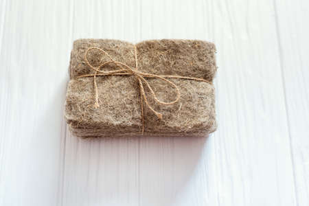 Packs of linen mats on white wooden background. Microgreens planting supply business. natural base for growing plants. Vitamins from nature. Vegan and healthy superfood delivery service.の写真素材