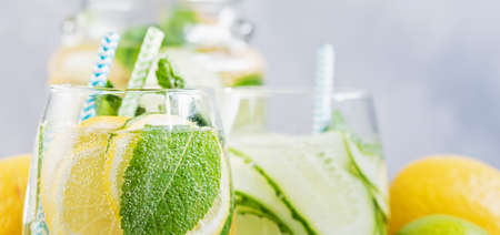 Detox refreshing sassy water with cucumber, ginger, mint and lemon in glasses, Healthy eating concept. Light background. Close-up. Body detoxication. Hard Seltzer.の写真素材