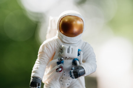 toy astronaut standing on ground. Spaceman figure Travel concept environmental protection. Astronaut...