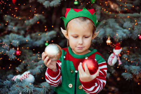 Christmas in july. children elf ears. Child waiting for Christmas in wood in july. portrait of...