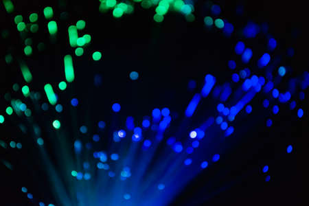abstract blue and red on black bokeh background overlay layer. sparks and blowing. festive background. Sparkling magical dust particles.の写真素材
