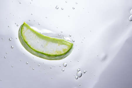 Aloe vera slice texture with gel on light background. Medicinal plant. Flat lay. Top view. Natural herbal medical plant, skincare, healthcare and beauty spa concept.の写真素材