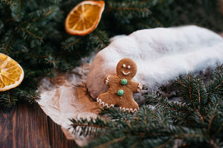 Christmas stollen on wooden background. Traditional christmas german dessert cut into pieces. Cake with nuts, raisins with marzipan and dried fruit on cutting board. baking for xmasの写真素材