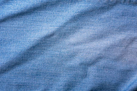 Old Blue jeans fabric denim texture background for design. Canvas denim. Close up view.の写真素材