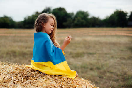 Ukraines Independence Flag Day. Constitution day. Ukrainian child girl in embroidered shirt...