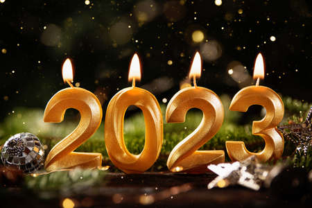 Holiday background Happy New Year 2023. Numbers of year 2023 made by gold burning candles on bokeh festive sparkling background. celebrating New Year holiday, close-up. Space for textの写真素材