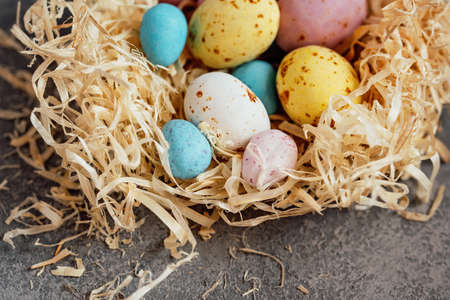Happy Easter holiday concept. Copy space. nest decorations background with chocolate Easter eggs....