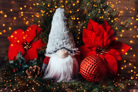 Merry christmas. Christmas composition with gnome and festive decorations on wooden background. Christmas or New Year greeting card. Noel gnome background. Christmas symbol. Happy Holidays.の写真素材