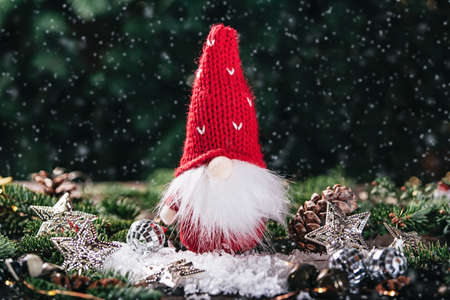 Merry christmas. Christmas composition with gnome and festive decorations on wooden background. Christmas or New Year greeting card. Noel gnome background. Christmas symbol. Happy Holidays.の写真素材