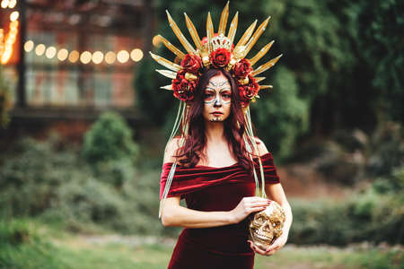 Young woman with painted skull on her face for Mexicos Day of the Dead. portrait of Calavera Catrina...