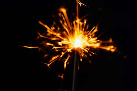 Close view of sparkler on black background. soft selective focus. abstract bokeh background, copy space. Christmas or New Year composition. Christmas card.の写真素材