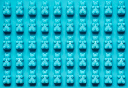 Blue silicone mold texture bear for candies. Candy cup, silicone mold for preparation homemade jelly candy, bakeware. Top view, flat layの写真素材