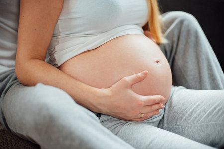 Young couple expecting baby. Pregnant woman with husband. pregnancy people and expectation childbearing concept. Copyspace. Front view. Man hugging pregnant woman.の写真素材