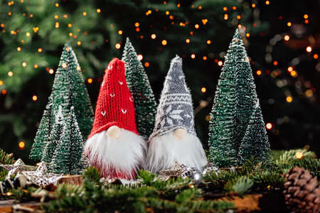 Merry christmas. Christmas composition with gnome and festive decorations on wooden background. Christmas or New Year greeting card. Noel gnome background. Christmas symbol. Happy Holidays.の写真素材