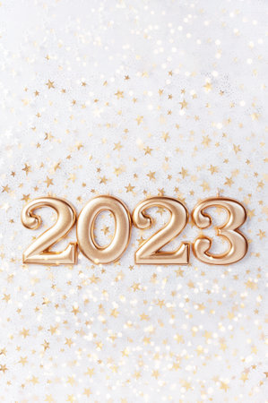 Holiday background Happy New Year 2023. Numbers of year 2023 made by gold candles on bokeh festive sparkling background. celebrating New Year holiday, close-up. Space for textの写真素材