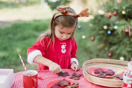Christmas in july. Child waiting for Christmas in wood in july. portrait of little girl drinking hot...