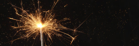 Close view of sparkler on black background. soft selective focus. abstract bokeh background, copy space. Christmas or New Year composition. Christmas card.の写真素材