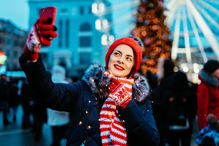 cute lovely woman in warm clothes on christmas market outdoors in winter snow day. Christmas Big...