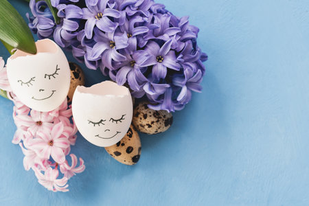 Easter background with blue eggs and spring flowers. Top view with copy space. Happy Easter Spring...
