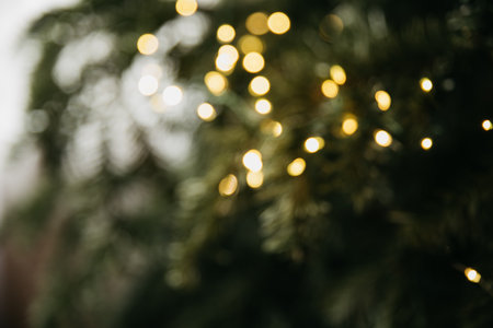 Light bokeh defocused background. Blurred photo of Christmas tree lights. golden light effects....
