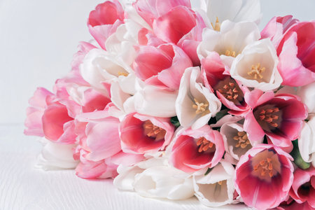 greeting card for spring holiday Happy mothers day composition. Beautiful background of bouquet of pink and white tulips. perfect for romantic themes, wedding invitations, and feminine branding.の写真素材