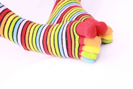 woman legs in strip sock on white backgroundの写真素材