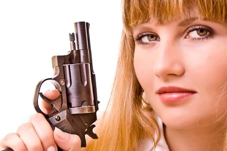 Young woman with gun isolated on whiteの写真素材